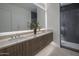 Modern bathroom featuring double vanity, a shower with glass door, and contemporary fixtures at 37200 N Cave Creek Rd # 2110, Scottsdale, AZ 85262
