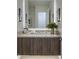 Modern bathroom vanity features a light countertop and wood cabinets with sleek, vertical hardware at 37200 N Cave Creek Rd # 2110, Scottsdale, AZ 85262