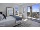Sunlit bedroom with a private balcony, offering views of the surrounding cityscape and blue skies at 37200 N Cave Creek Rd # 2110, Scottsdale, AZ 85262