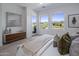 Inviting bedroom featuring two large windows and a light-colored wood cabinet at 37200 N Cave Creek Rd # 2110, Scottsdale, AZ 85262