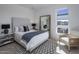 Bright bedroom with a large mirror, neutral furniture, and a patterned black and white rug at 37200 N Cave Creek Rd # 2110, Scottsdale, AZ 85262