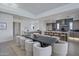 Bright, open-concept dining area with a long table and seating for ten, next to a modern kitchen at 37200 N Cave Creek Rd # 2110, Scottsdale, AZ 85262