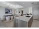 Open kitchen and dining area, with waterfall island, wood cabinets and a view out the clerestory windows at 37200 N Cave Creek Rd # 2110, Scottsdale, AZ 85262