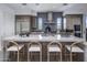 Spacious kitchen island with seating and stainless steel appliances, wood cabinets, marble countertops at 37200 N Cave Creek Rd # 2110, Scottsdale, AZ 85262