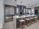Stylish kitchen with stainless steel appliances, a waterfall island, and wood cabinets at 37200 N Cave Creek Rd # 2110, Scottsdale, AZ 85262