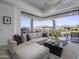 Living room with neutral sectional, dark wood coffee table, and large sliding doors to the outdoor patio at 37200 N Cave Creek Rd # 2110, Scottsdale, AZ 85262