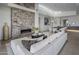 Cozy living room featuring a stone fireplace and a plush white sofa under clerestory windows at 37200 N Cave Creek Rd # 2110, Scottsdale, AZ 85262