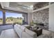 Bright living room with stone fireplace, comfortable seating, and sliding doors to the outdoor patio at 37200 N Cave Creek Rd # 2110, Scottsdale, AZ 85262