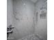 Bathroom shower with rainfall showerhead and pebble floor is tiled with cream-colored marble at 37200 N Cave Creek Rd # 2110, Scottsdale, AZ 85262
