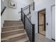 Modern staircase with wood treads, black metal railings, and an elevator, offering accessibility at 37200 N Cave Creek Rd # 2110, Scottsdale, AZ 85262