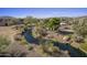 Scenic view of a peaceful pond with a bocce ball court near luxury homes at 37200 N Cave Creek Rd # 2110, Scottsdale, AZ 85262