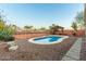 Relaxing kidney shaped pool with pergola and desert landscaping at 3932 N Silver King Ln, Casa Grande, AZ 85122