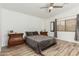 Bedroom with gray bedding, wood-look tile flooring, and ceiling fan at 3932 N Silver King Ln, Casa Grande, AZ 85122