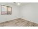 Small bedroom with wood-look tile flooring and window at 3932 N Silver King Ln, Casa Grande, AZ 85122