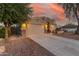 House exterior with driveway, landscaping, and sunset view at 3932 N Silver King Ln, Casa Grande, AZ 85122