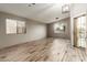 Bright living room featuring wood-look tile flooring and a view to the front yard at 3932 N Silver King Ln, Casa Grande, AZ 85122