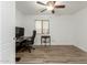 Home office with desk, chair, and wood-look tile flooring at 3932 N Silver King Ln, Casa Grande, AZ 85122
