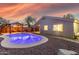 Scenic view of a backyard pool at sunset, featuring a pergola and home at 3932 N Silver King Ln, Casa Grande, AZ 85122