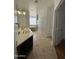 Bathroom boasts double vanity, a large soaking tub, and tile floors at 12827 S Hermit Rd, Buckeye, AZ 85326