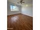 Bright bedroom with wood-look floors and large window at 12827 S Hermit Rd, Buckeye, AZ 85326