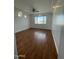 Spacious bedroom with wood-look floors and large window at 12827 S Hermit Rd, Buckeye, AZ 85326