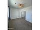 Well-lit bedroom with carpet flooring and mirrored closet doors at 12827 S Hermit Rd, Buckeye, AZ 85326
