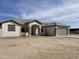 Single story home with gray garage door and stone accents at 12827 S Hermit Rd, Buckeye, AZ 85326