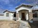 Single story home with wood door and stone accents at 12827 S Hermit Rd, Buckeye, AZ 85326