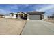 Single story home with gray garage door and stone accents at 12827 S Hermit Rd, Buckeye, AZ 85326
