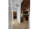 Hallway with tile flooring, built-in wet bar, and kitchen access at 12827 S Hermit Rd, Buckeye, AZ 85326