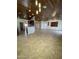 Spacious living room featuring high ceilings, tile floors, and a ceiling fan at 12827 S Hermit Rd, Buckeye, AZ 85326