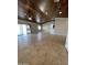 Bright living room with tile floors, sliding doors, and a ceiling fan at 12827 S Hermit Rd, Buckeye, AZ 85326