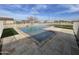 L-shaped pool with large patio and fenced backyard at 12827 S Hermit Rd, Buckeye, AZ 85326