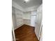 Large walk-in closet with wood-look floors and shelving at 12827 S Hermit Rd, Buckeye, AZ 85326