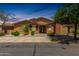 Charming single-story home with desert landscaping, neutral stucco and brick, and a welcoming front porch at 13421 N 151St Dr, Surprise, AZ 85379