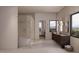 Contemporary bathroom with a glass enclosed shower, floating vanity, and large windows for natural light and scenic views at 12232 N 65Th Pl, Scottsdale, AZ 85254