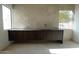 Bathroom with dark wood floating vanity, tiled accent wall, and modern fixtures at 12232 N 65Th Pl, Scottsdale, AZ 85254