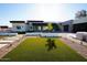 Modern home showcasing green lawn, a stone driveway, and clean, modern landscaping at 12232 N 65Th Pl, Scottsdale, AZ 85254