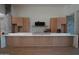 New kitchen with light wood cabinets, stone accents, and white marble countertops at 12232 N 65Th Pl, Scottsdale, AZ 85254