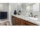 Bathroom featuring double sinks, granite countertops, and wood cabinets at 38334 N 20Th St, Phoenix, AZ 85086