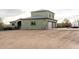 Exterior view of the home's three-car garage, basketball court, and desert landscape at 38334 N 20Th St, Phoenix, AZ 85086