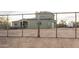 Exterior view of the home's gated yard, three-car garage, and desert landscape, perfect for a Gathering at 38334 N 20Th St, Phoenix, AZ 85086