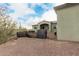 Exterior front view of home behind a gated yard, showcasing desert landscape at 38334 N 20Th St, Phoenix, AZ 85086