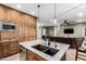 Kitchen island featuring a granite countertop, stainless steel dishwasher, sink, and custom cabinets at 38334 N 20Th St, Phoenix, AZ 85086