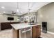 Kitchen island featuring a granite countertop, stainless steel dishwasher, sink and modern water cooler at 38334 N 20Th St, Phoenix, AZ 85086