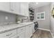 Laundry room with granite countertops, white cabinets and new appliances at 38334 N 20Th St, Phoenix, AZ 85086