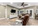 Open-concept living room with entertainment center, wood-look floors and lots of natural light at 38334 N 20Th St, Phoenix, AZ 85086