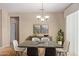 Bright dining room with a modern table and chandelier at 15824 W Sage Trl, Surprise, AZ 85374