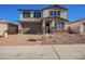 Two-story house with a large garage and a landscaped front yard at 11519 S 50Th Ave, Laveen, AZ 85339