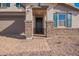 Two-story house with stone accents, dark-green shutters, and a paved walkway at 11519 S 50Th Ave, Laveen, AZ 85339